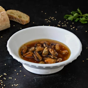 Maple smoked mussels with roasted sesame tamari sauce in a bowl